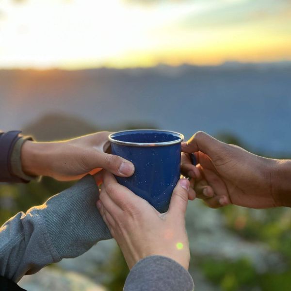 A mug being held by four hands